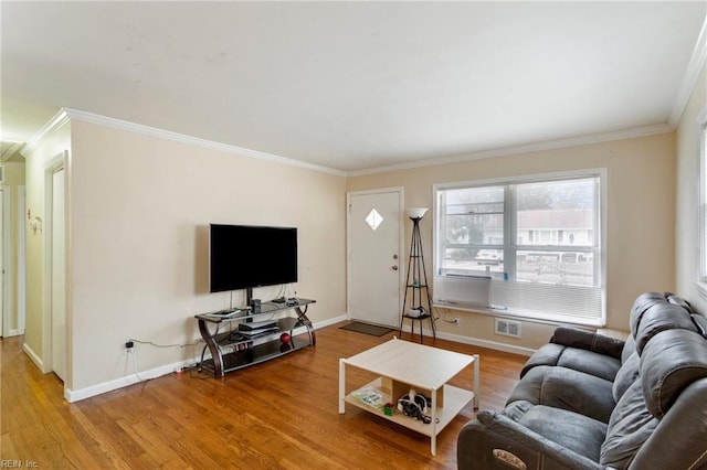 living room featuring cooling unit, hardwood / wood-style floors, and ornamental molding