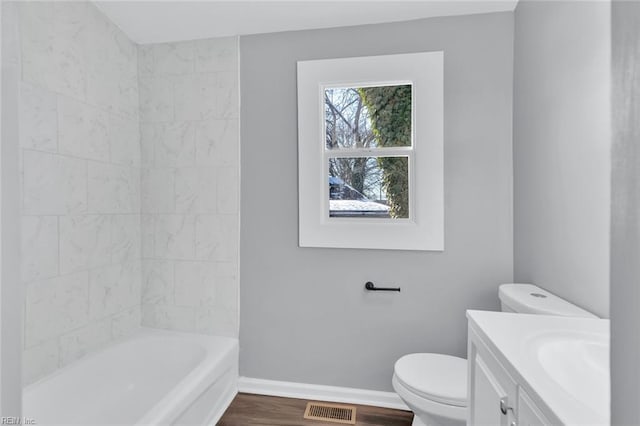 bathroom featuring vanity, hardwood / wood-style flooring, and toilet