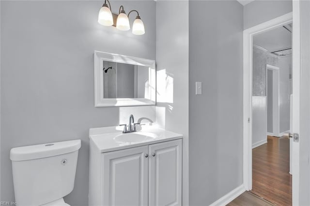 bathroom featuring vanity, hardwood / wood-style floors, and toilet