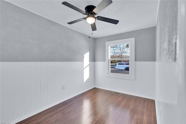 additional living space featuring ceiling fan and dark hardwood / wood-style flooring