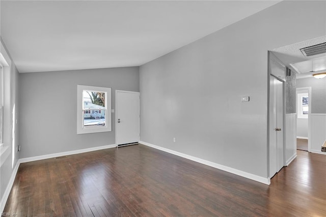 empty room featuring lofted ceiling and dark hardwood / wood-style floors