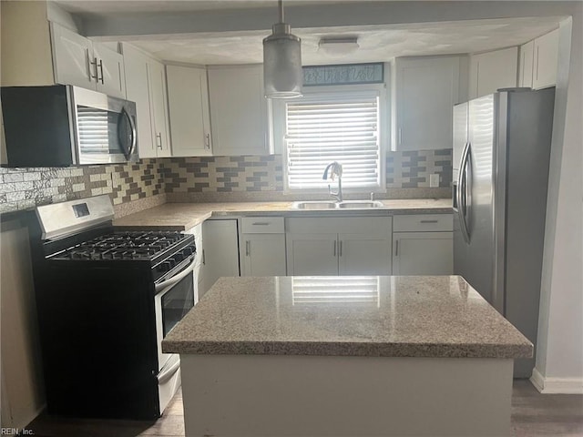 6336 Old Townpoint Rd, Suffolk, VA 23435 - kitchen with pendant lighting, appliances with stainless steel finishes, sink, and white cabinets