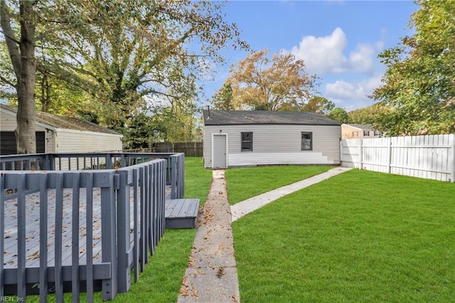 view of yard with a deck and a storage shed