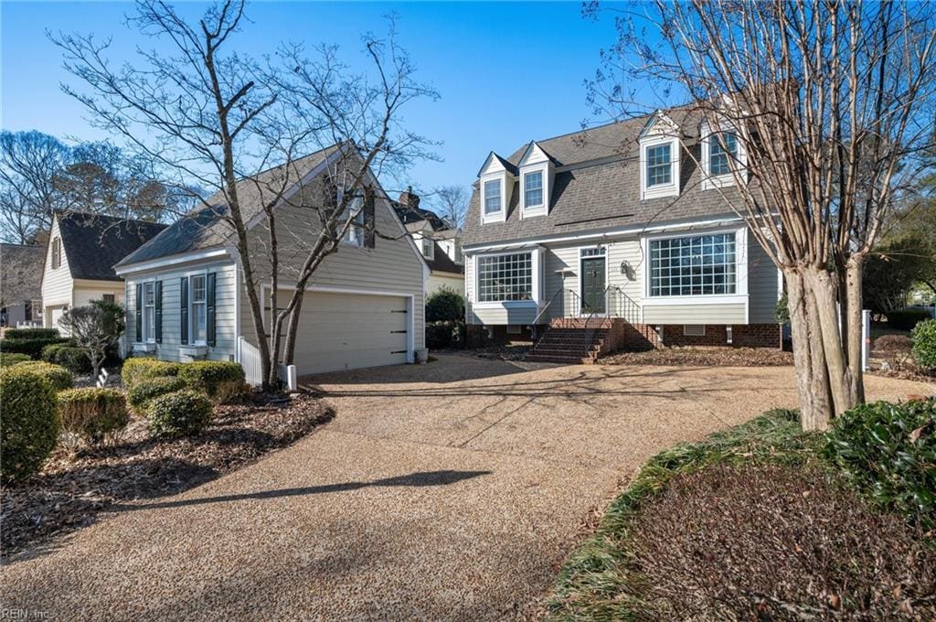 cape cod house with a garage