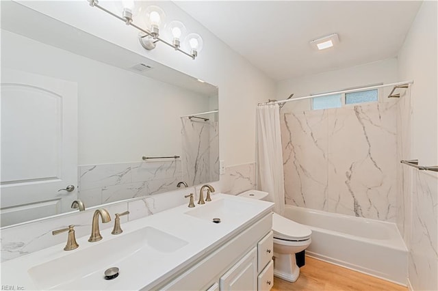 full bathroom featuring shower / bathtub combination with curtain, vanity, wood-type flooring, and toilet