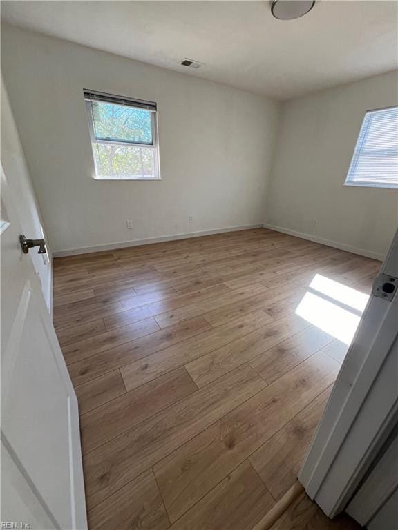 spare room with light hardwood / wood-style flooring