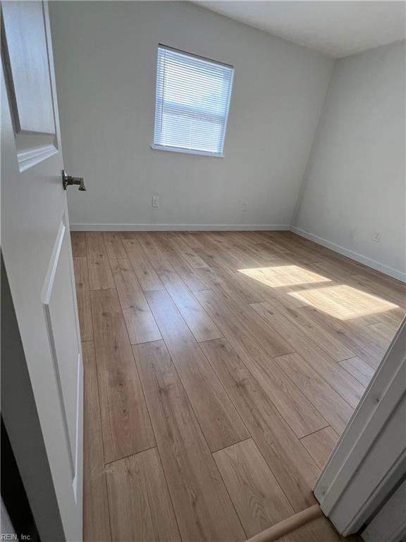 spare room with light wood-type flooring