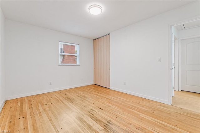 empty room with light hardwood / wood-style flooring