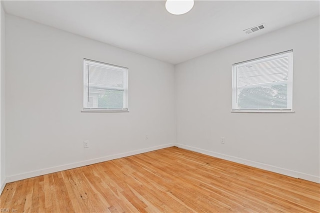 unfurnished room with light wood-type flooring