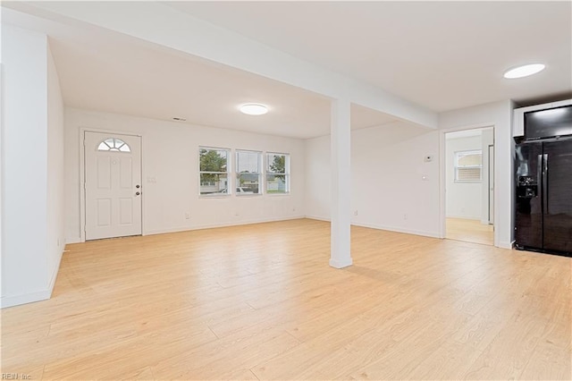 unfurnished living room featuring light wood-type flooring