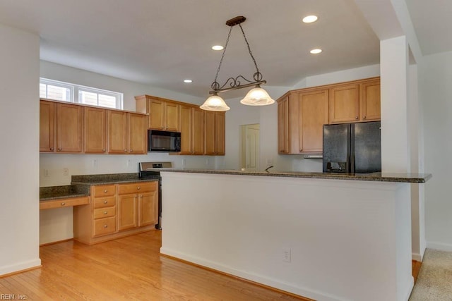 kitchen with decorative light fixtures, built in desk, kitchen peninsula, dark stone counters, and black appliances