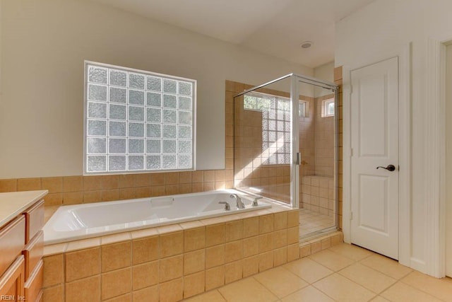 bathroom with vanity, shower with separate bathtub, and tile patterned flooring