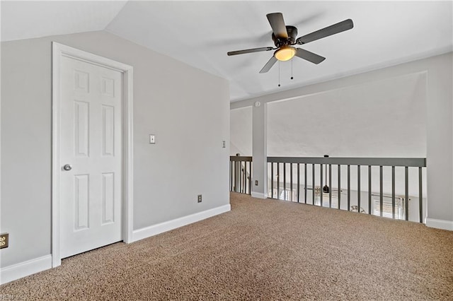 unfurnished room with ceiling fan, vaulted ceiling, and carpet