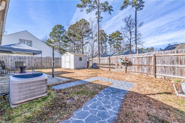 view of yard with a storage shed and central air condition unit