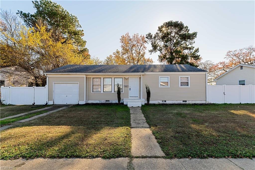 view of front of property with a garage and a front lawn