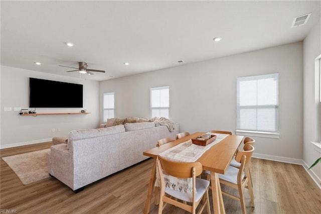 dining room with ceiling fan and light wood-type flooring