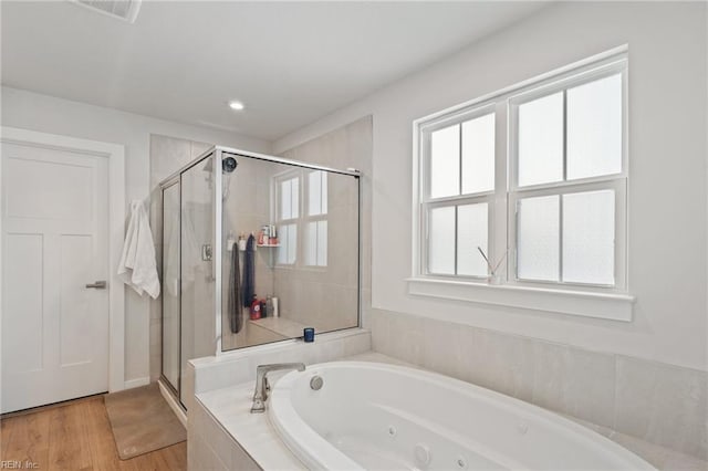 bathroom featuring hardwood / wood-style floors and independent shower and bath