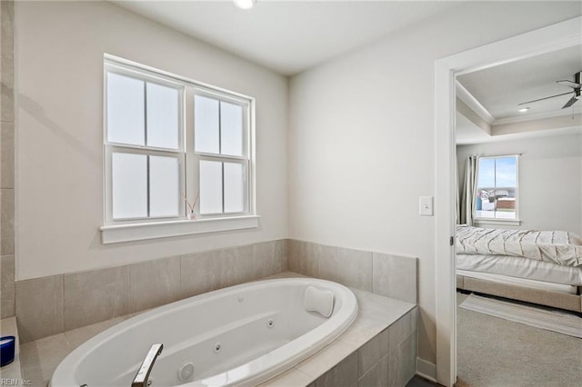 bathroom with ceiling fan and tiled tub