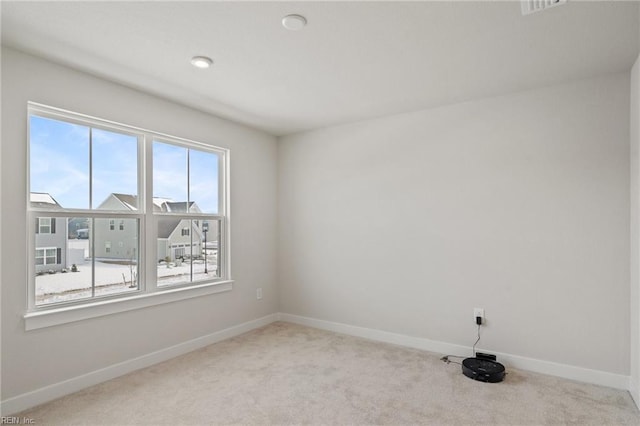 spare room with light colored carpet