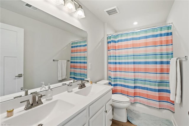 full bathroom featuring shower / tub combo with curtain, vanity, and toilet