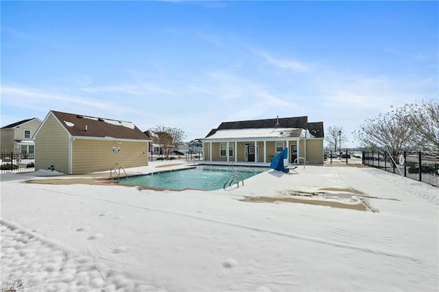 snow covered pool with a patio