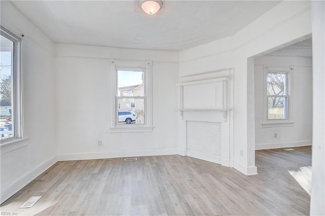 unfurnished room with light hardwood / wood-style flooring