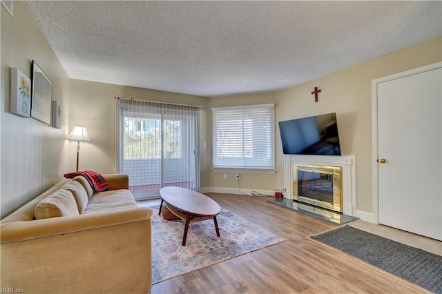 living room featuring light hardwood / wood-style flooring and a textured ceiling