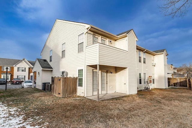 rear view of house with central AC unit and a patio