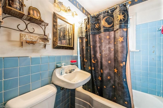 full bathroom with tile walls, shower / tub combo, sink, and toilet