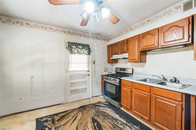 kitchen featuring ceiling fan, sink, and gas stove