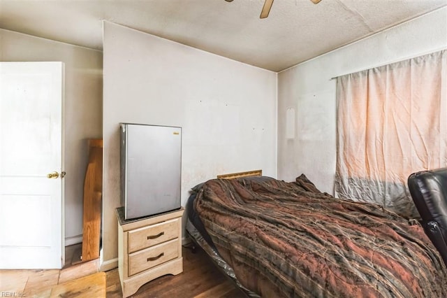 bedroom with ceiling fan and dark hardwood / wood-style flooring