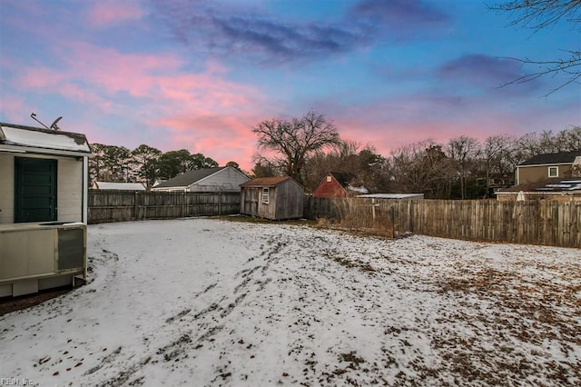 snowy yard with a storage unit