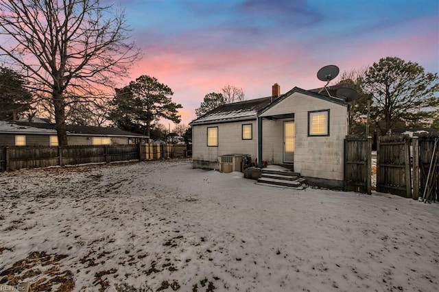 view of back house at dusk