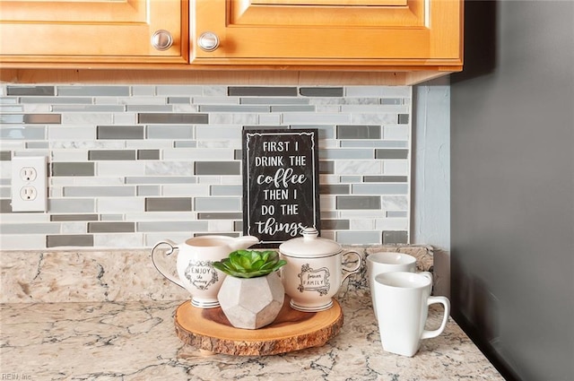 room details with light stone counters and backsplash