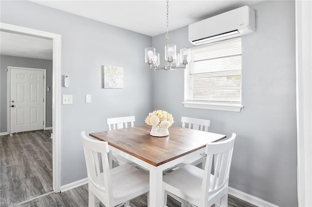 dining area featuring dark hardwood / wood-style flooring, a notable chandelier, and a wall mounted AC