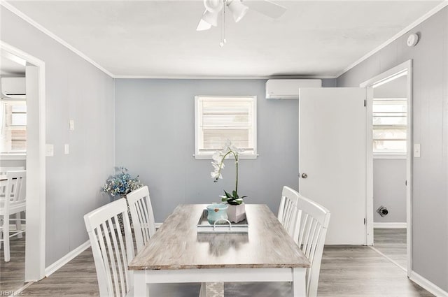 dining area with hardwood / wood-style flooring, crown molding, a wall mounted AC, and ceiling fan