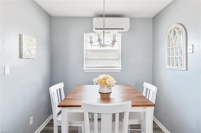 dining room featuring hardwood / wood-style floors, a notable chandelier, and a wall mounted AC