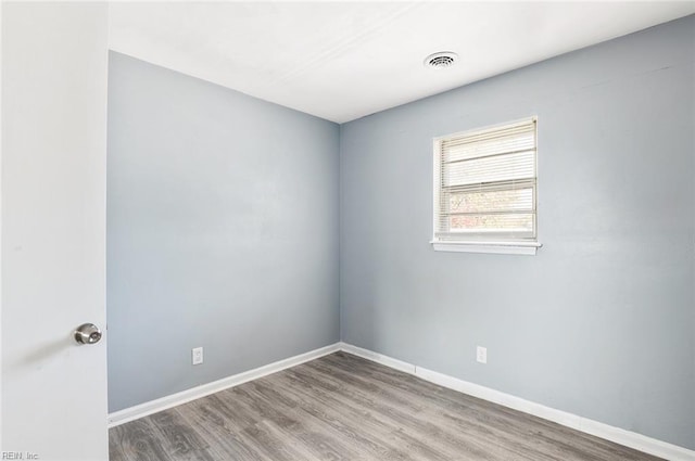 spare room featuring light hardwood / wood-style floors