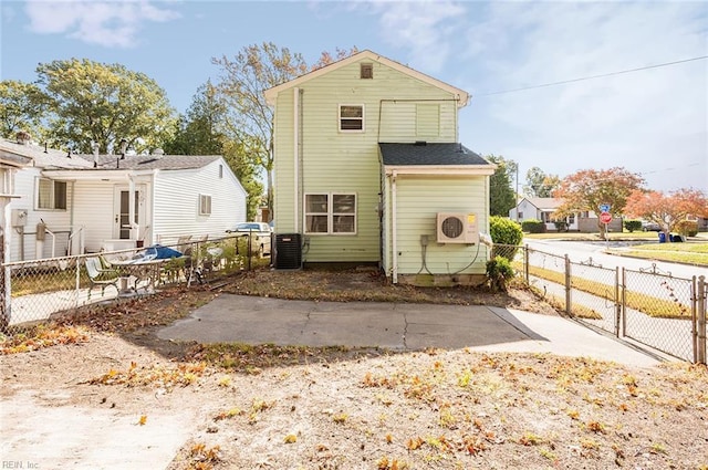 rear view of house featuring a patio, ac unit, and central AC