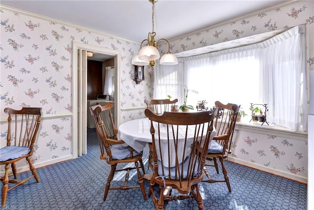 carpeted dining area with baseboards and wallpapered walls