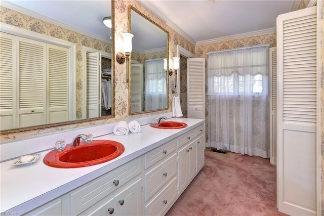 bathroom with a sink, wallpapered walls, and a closet