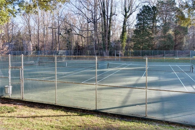 view of tennis court featuring fence