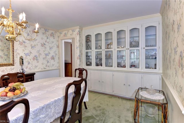 dining room featuring wainscoting, light carpet, a notable chandelier, and wallpapered walls