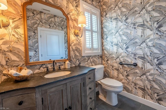 bathroom featuring vanity, tile patterned floors, and toilet