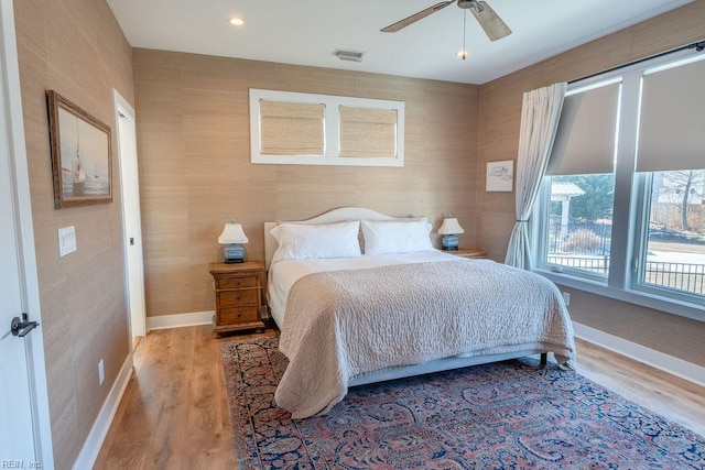 bedroom with ceiling fan and light hardwood / wood-style floors