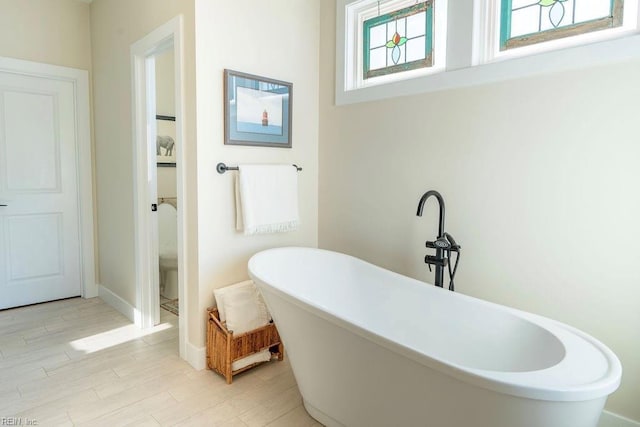 bathroom featuring wood-type flooring and a bathing tub