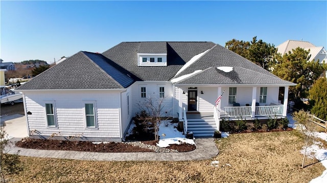 view of front facade with covered porch and a front yard