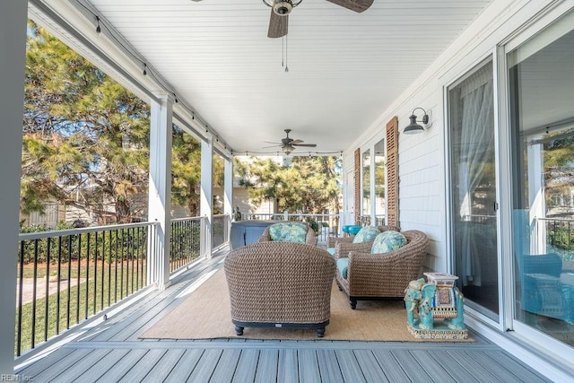 sunroom featuring ceiling fan