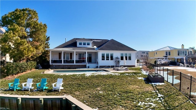 rear view of house with a fenced in pool, a yard, and a patio