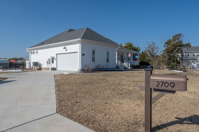 view of property exterior with a garage and a lawn